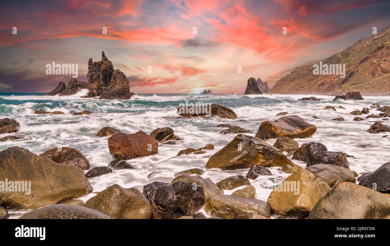 A mesmerizing view of a beautiful rocky seashore at scenic sunset Stock ...