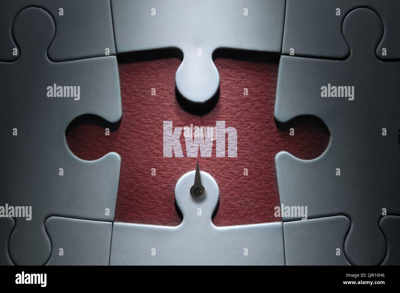 Missing piece from a jigsaw puzzle with dial pointing to kwh; energy usage concept Stock Photo