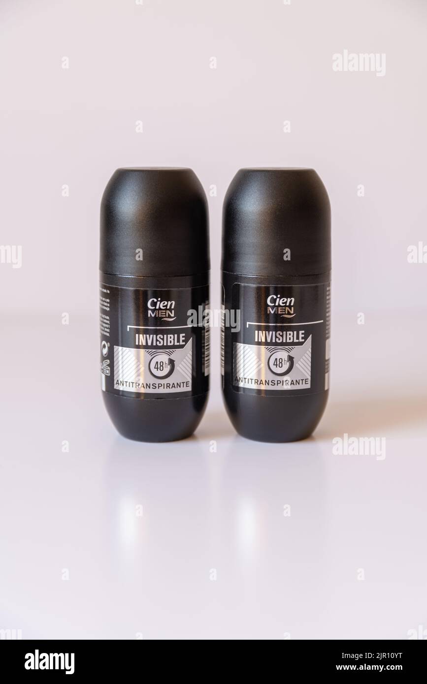 A vertical closeup of two deodorants of CIEN Rollon Men Invisible on white background Stock Photo