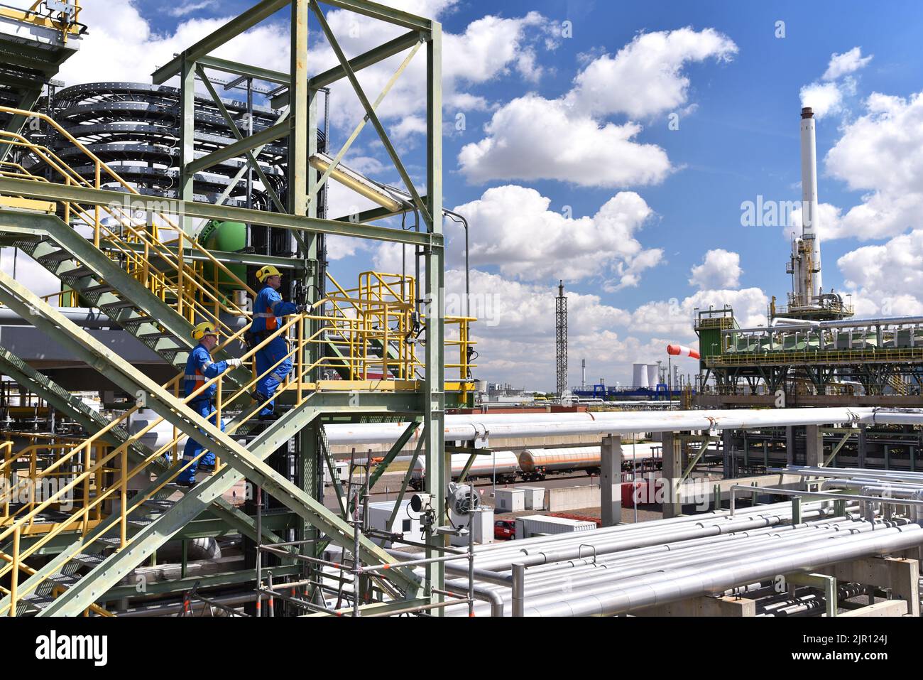 group of industrial workers in a refinery - oil processing equipment and machinery Stock Photo