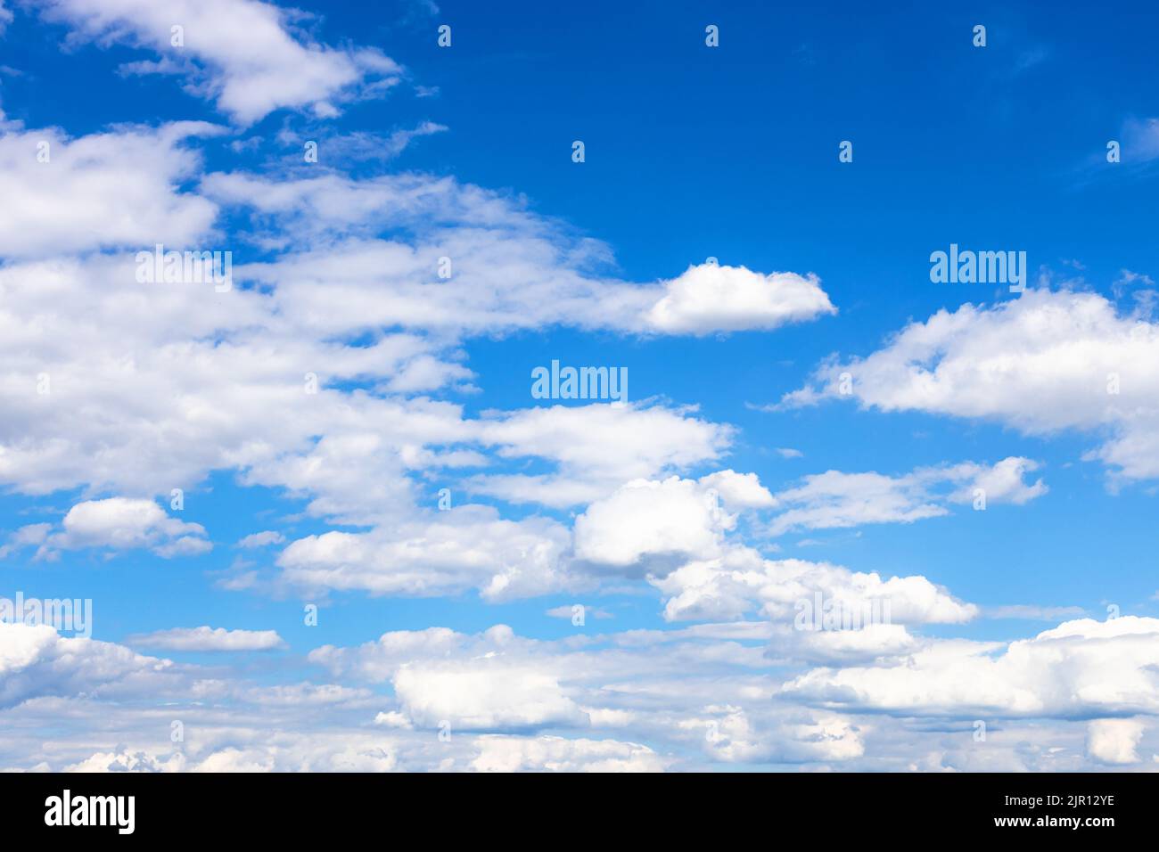 low white cumulus clouds in blue sky on sunny summer day over Moscow Stock Photo