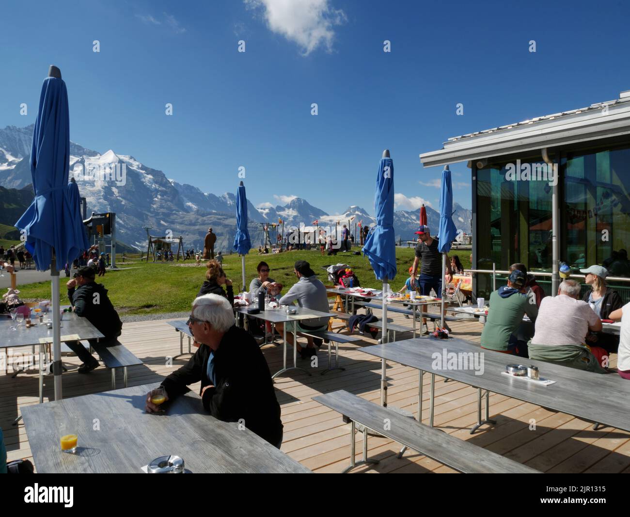 Enjoying lunch at the mountain restaurant at Mannlichen, Wengen, Bernese Oberland, Switzerland. Stock Photo