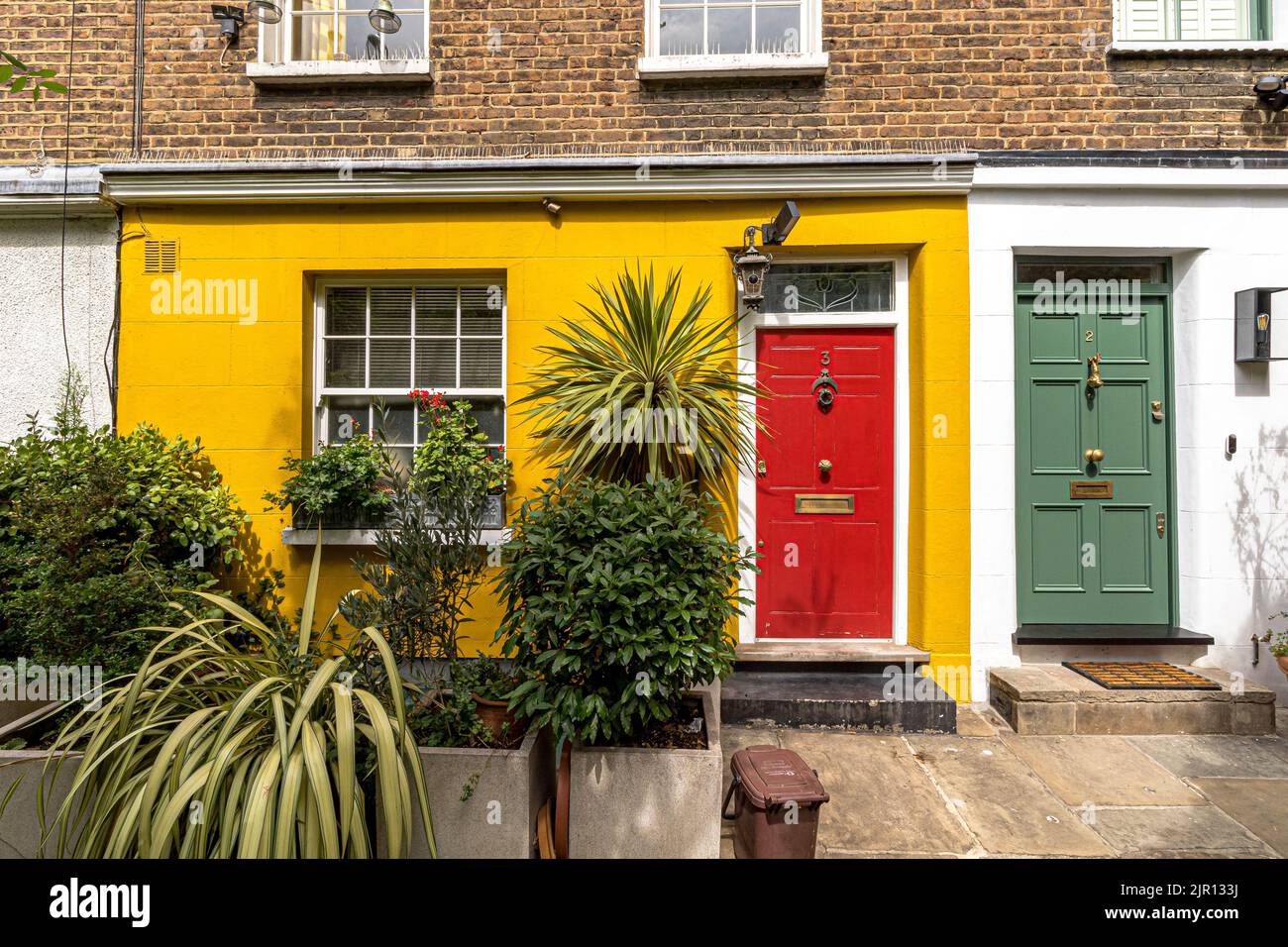 Brightly painted front doors on a row of houses situated along Colville