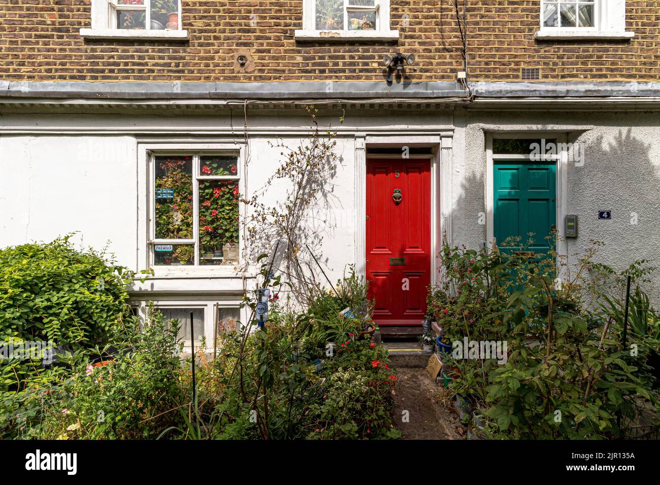Brightly painted front doors on a row of houses situated along Colville Place ,Fitzrovia, London W1 Stock Photo