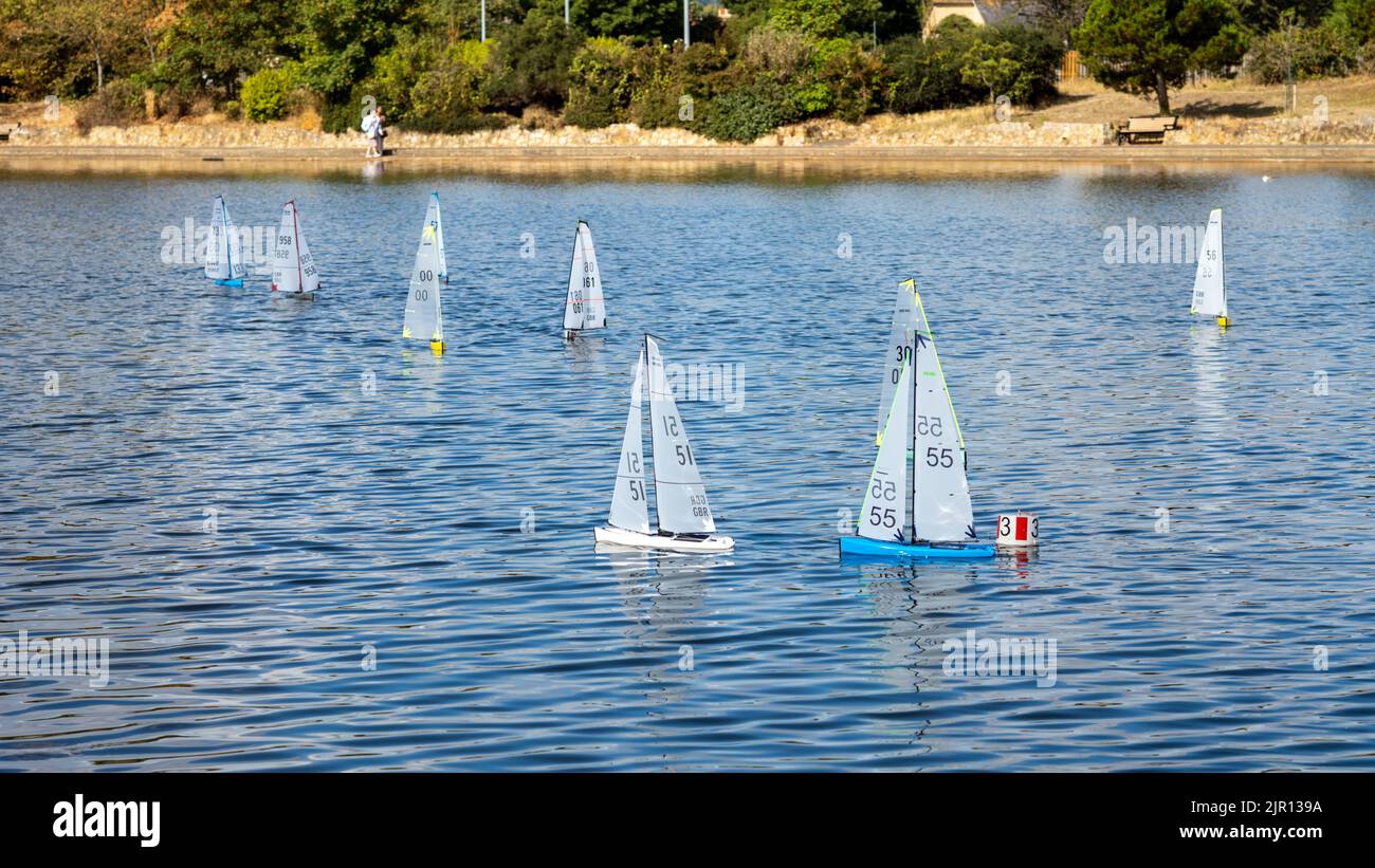 Radio controlled sailing boats and yachts participate in a race on a boating lake in Eastbourne, East Sussex, UK. Stock Photo