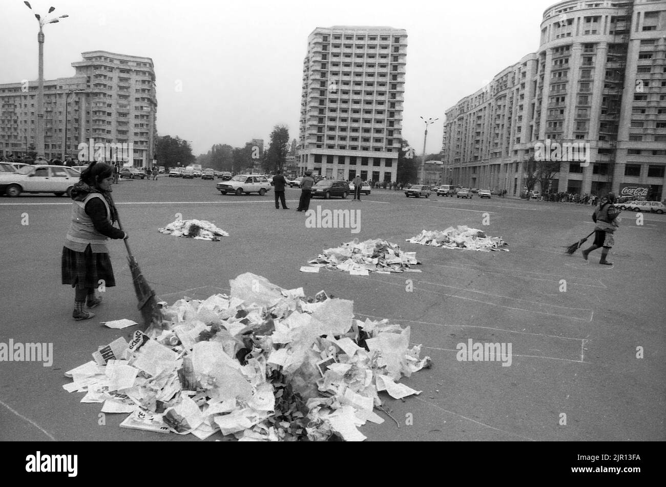 Bucharest, Romania, January 1990. Janitors cleaning up the streets in Victoria Square after a series of anti-governmental protests. Stock Photo