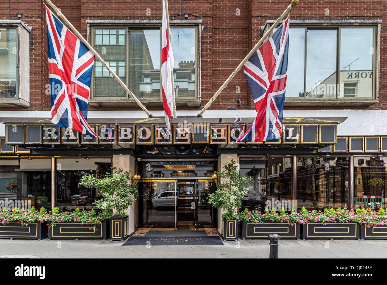 Union Flags displayed outside the front entrance to The Rathbone Hotel an intimate, boutique style hotel on Rathbone St in Fitzrovia , London W1 Stock Photo