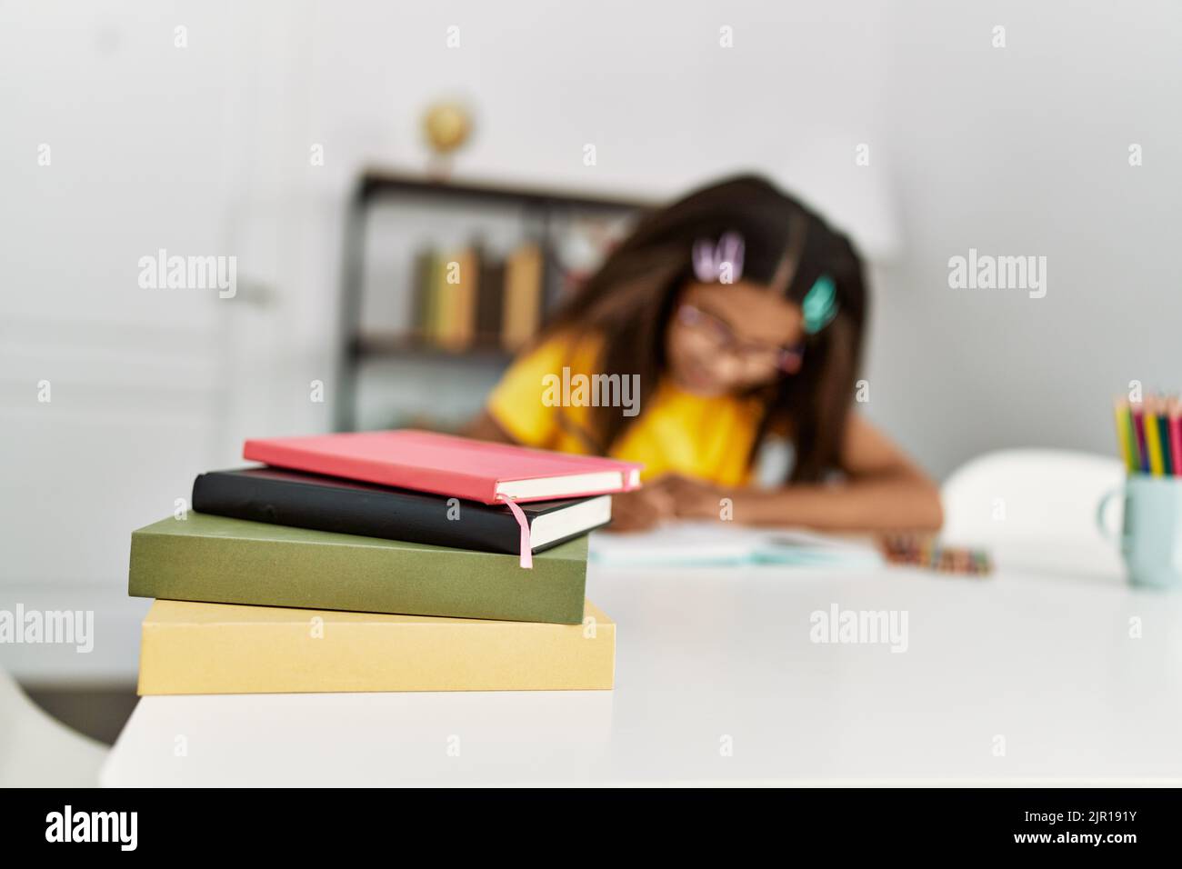 African girl smiling book desk hi-res stock photography and images - Alamy