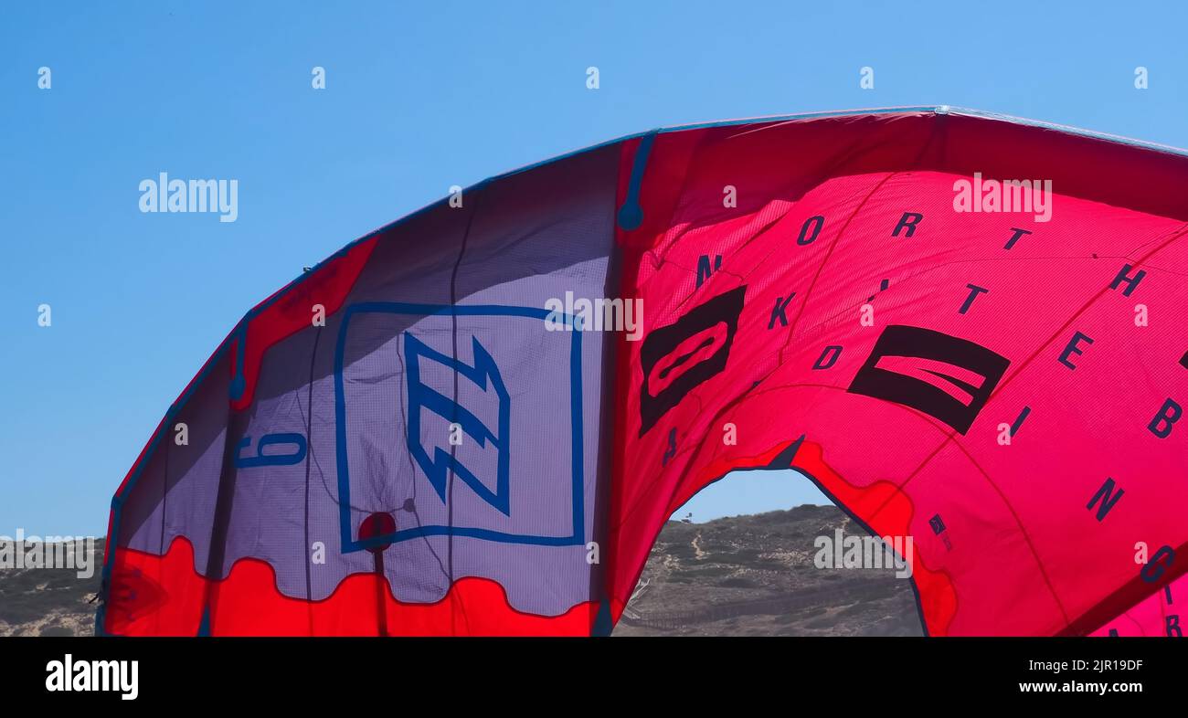 North kiteboarding kite surfing umbrella in red at the beach Stock