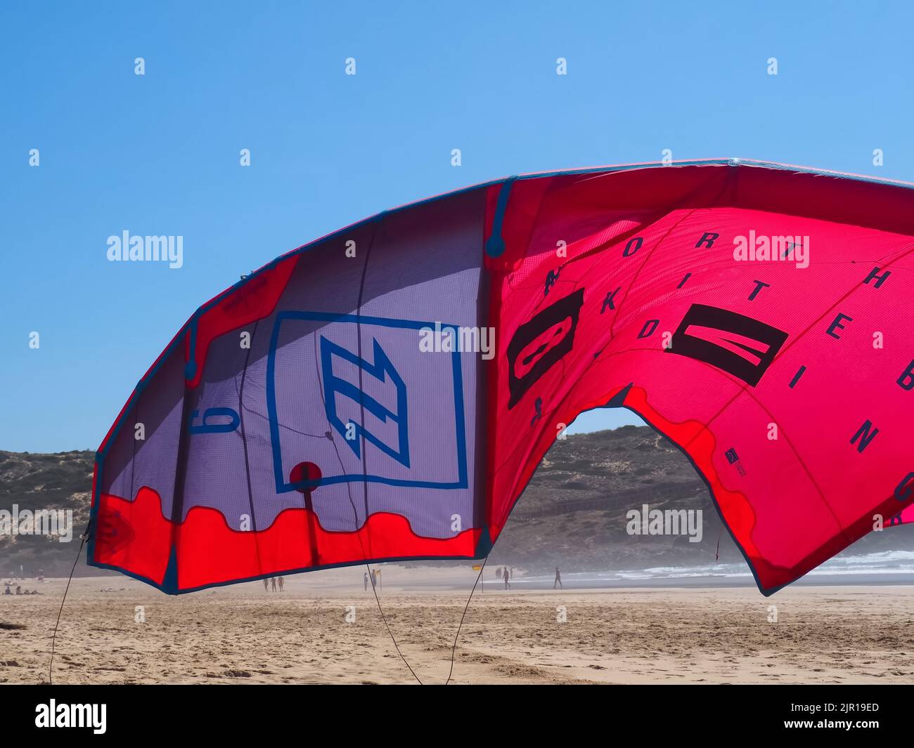 North kiteboarding kite surfing umbrella in red at the beach Stock