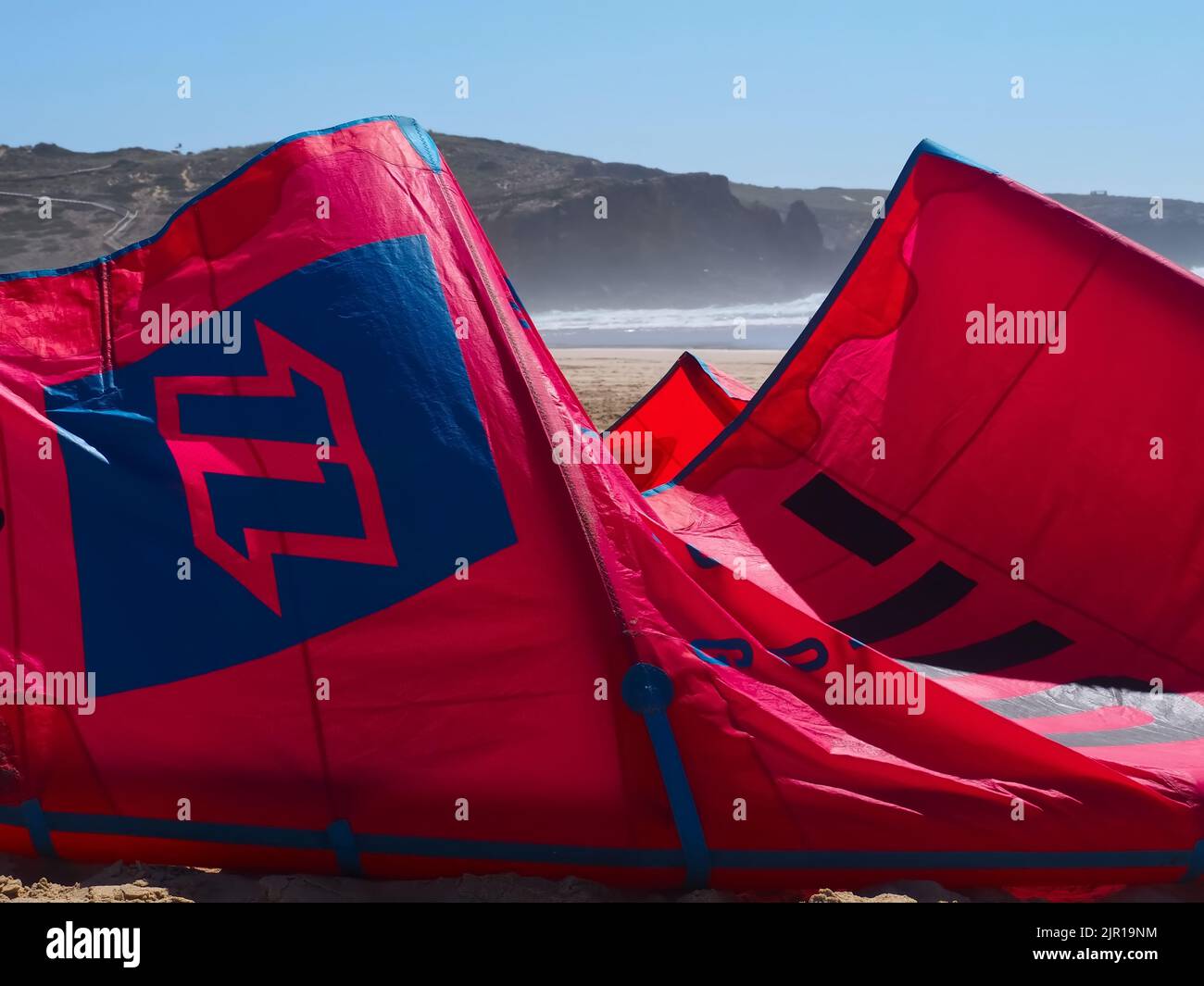 North kiteboarding kite surfing umbrella in red at the beach Stock