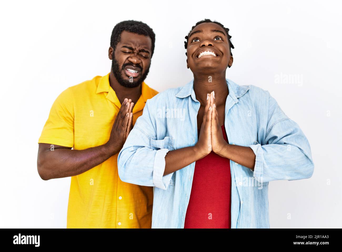 Young african american couple wearing casual clothes begging and ...