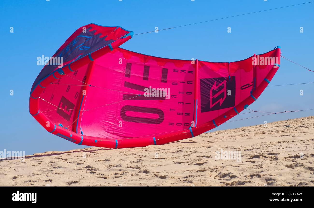 North kiteboarding kite surfing umbrella in red at the beach Stock
