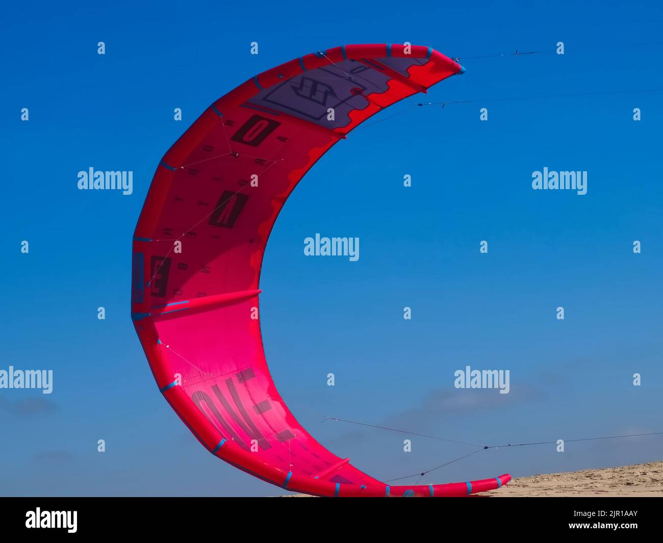 North kiteboarding kite surfing umbrella in red at the beach Stock