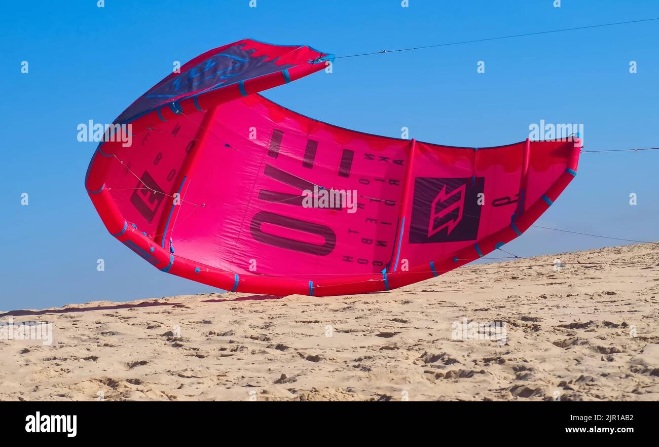 North kiteboarding kite surfing umbrella in red at the beach Stock
