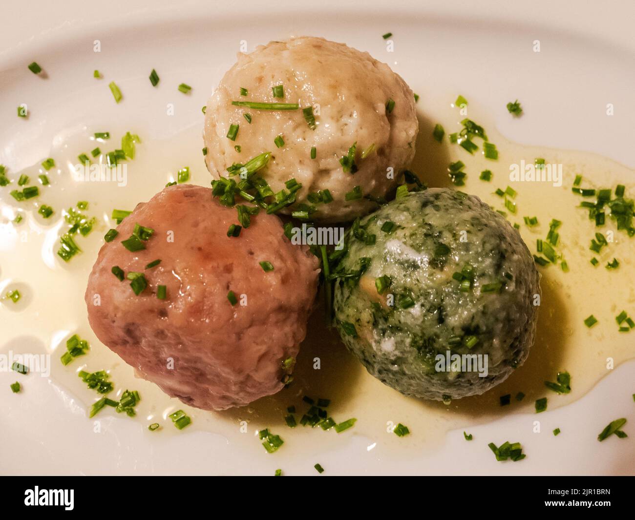 cheese dumpling, spinach dumpling and beetroot dumpling - South Tyrolean traditional food Stock Photo