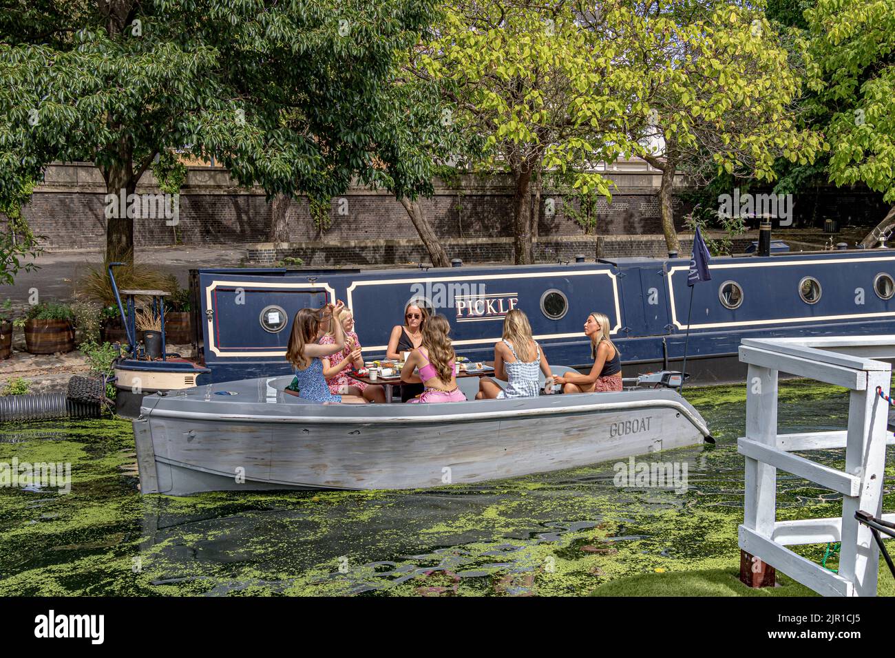 A group of girls taking a boat trip along the Paddington arm of the Grand Union Canal , Paddington ,London Stock Photo