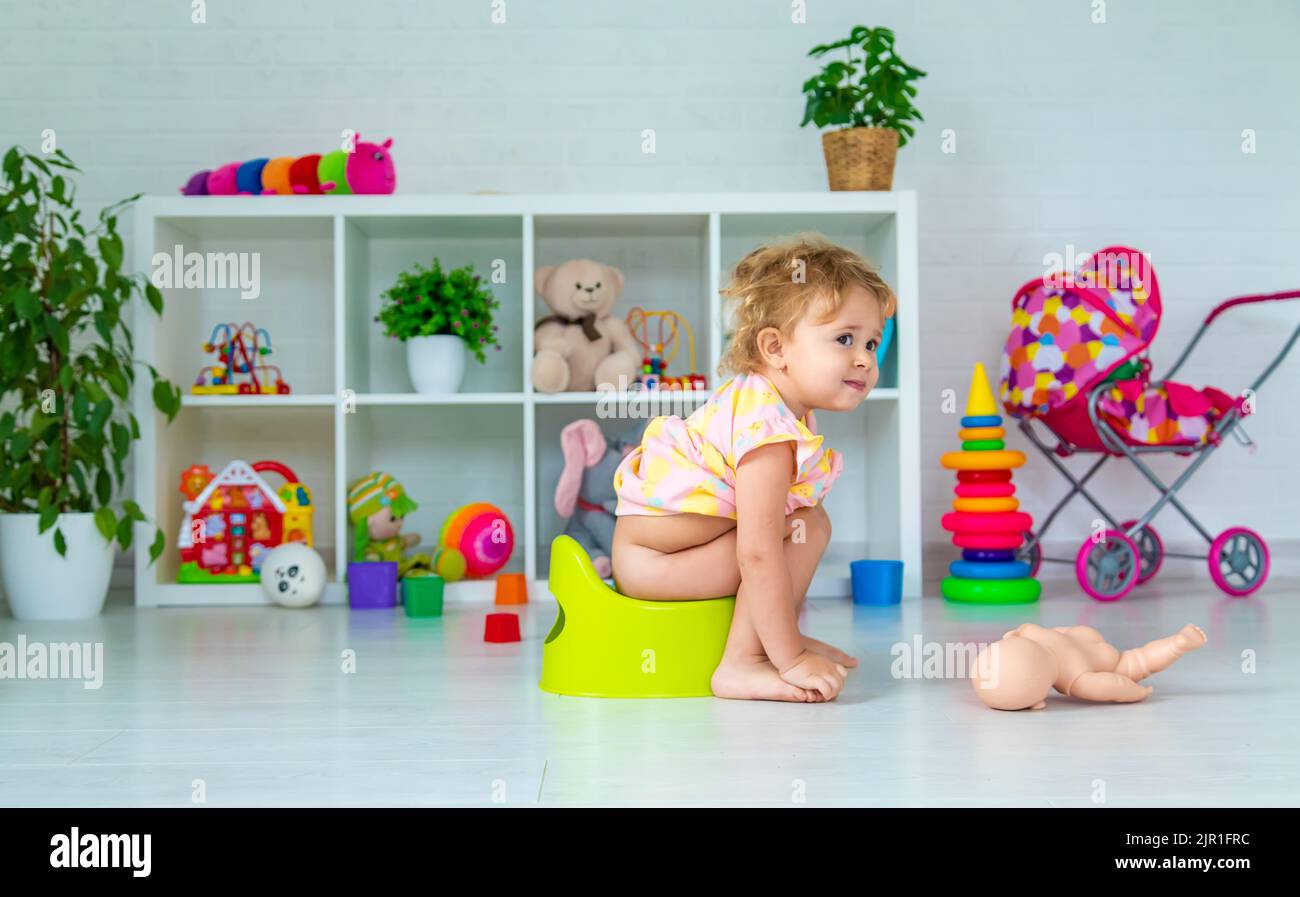 Children sit on the potty in the room. Selective focus. Kid Stock Photo