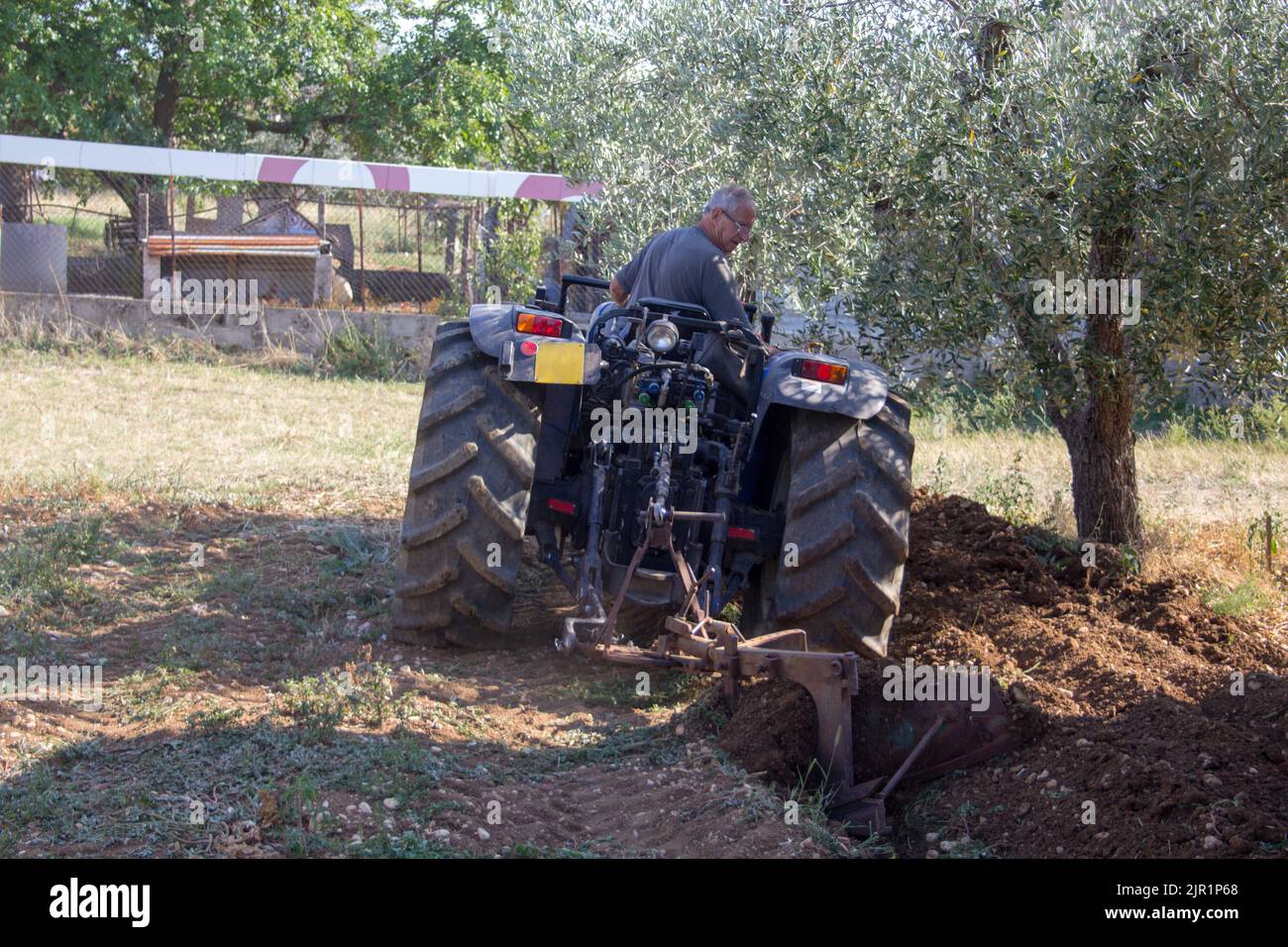 Image Of An Elderly Man Plowing The Land In His Tractor Soil Preparation Work For Sowing Stock Image Of An Elderly Man Plowing The Land In His Tractor Soil Preparation Work For Sowing Stock