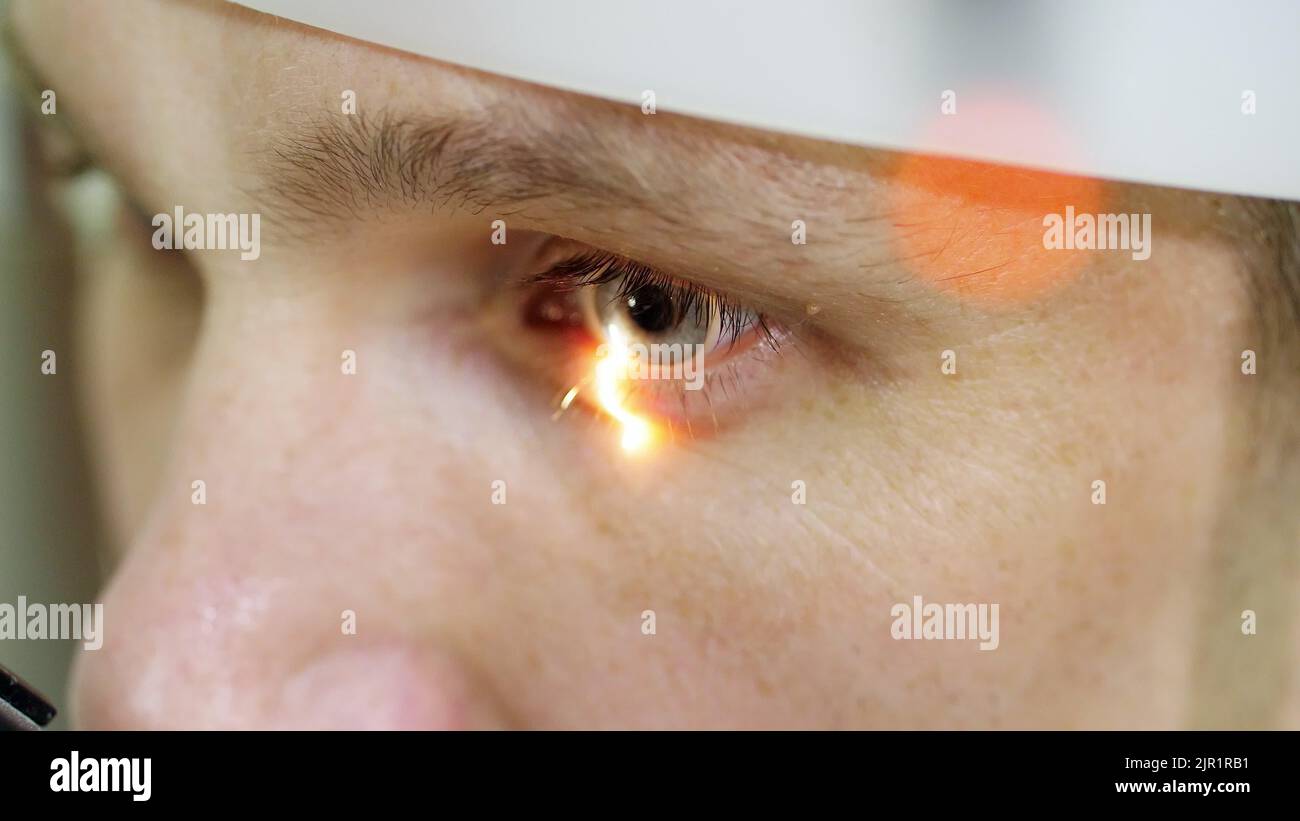 face close-up , man doing eye test with non contact tonometer, cheking vision, intraocular pressure at optical clinic, ophthalmilogical laboratory. High quality photo Stock Photo