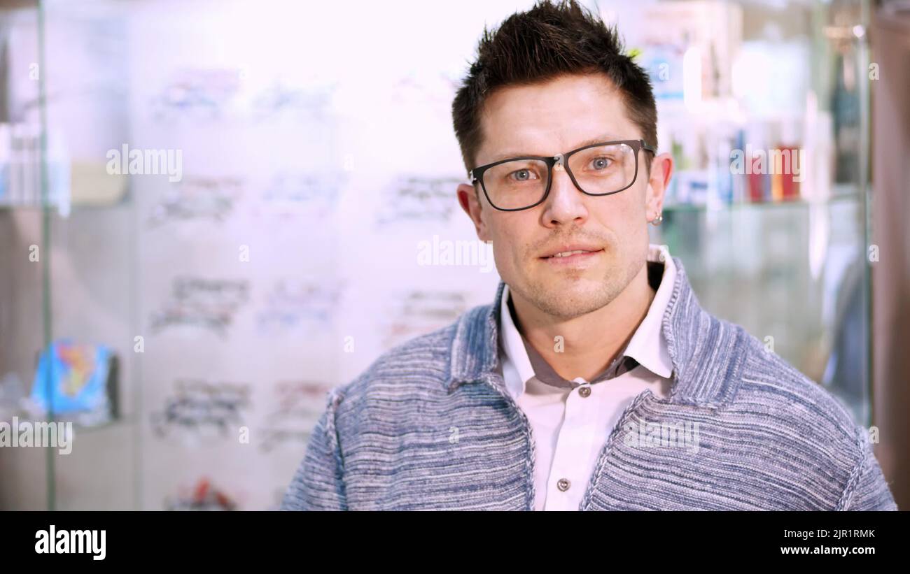 portrait of Handsome young man choosing eyeglasses special frame with