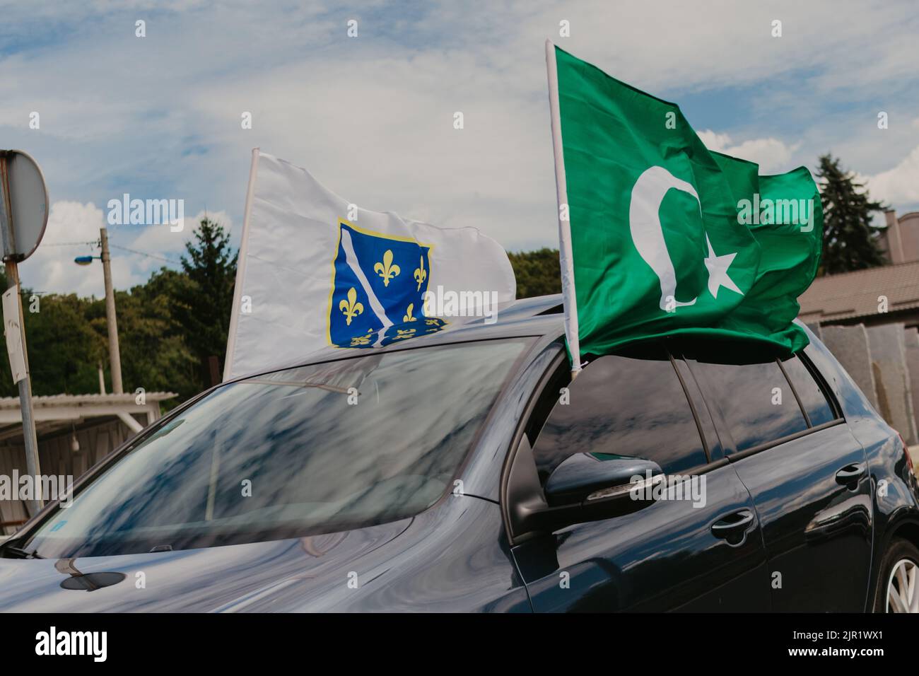The flag of Pakistan waving in the wind from a car Stock Photo