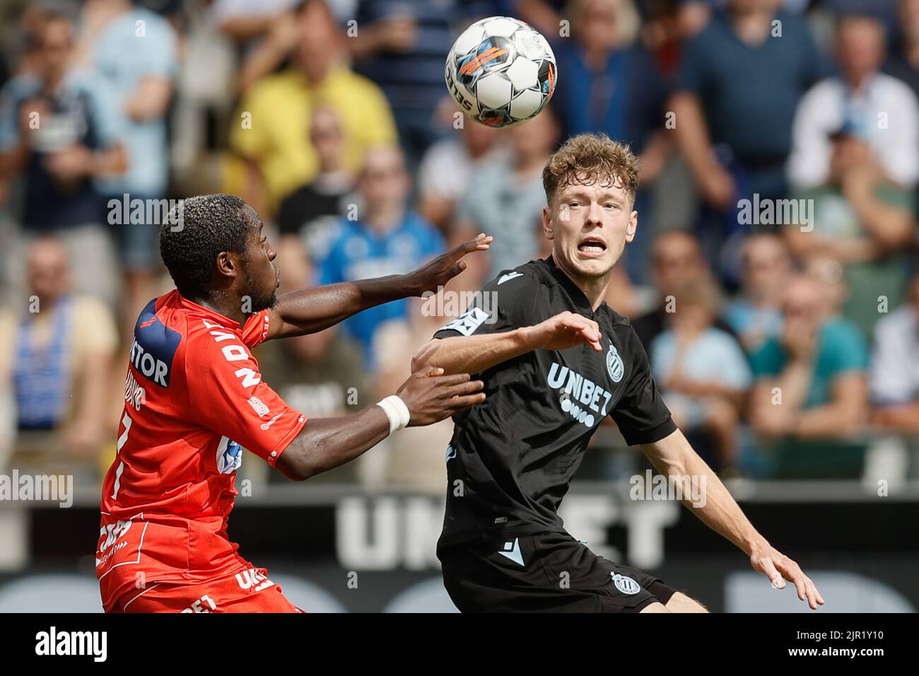Brugge, Belgium, 21 August 2022, Kortrijk's Dylan Mbayo and Club's Andreas Skov Olsen fight for the ball during a soccer match between Club Brugge and KV Kortrijk, Sunday 21 August 2022 in Brugge, on day 5 of the 2022-2023 'Jupiler Pro League' first division of the Belgian championship. BELGA PHOTO BRUNO FAHY Stock Photo