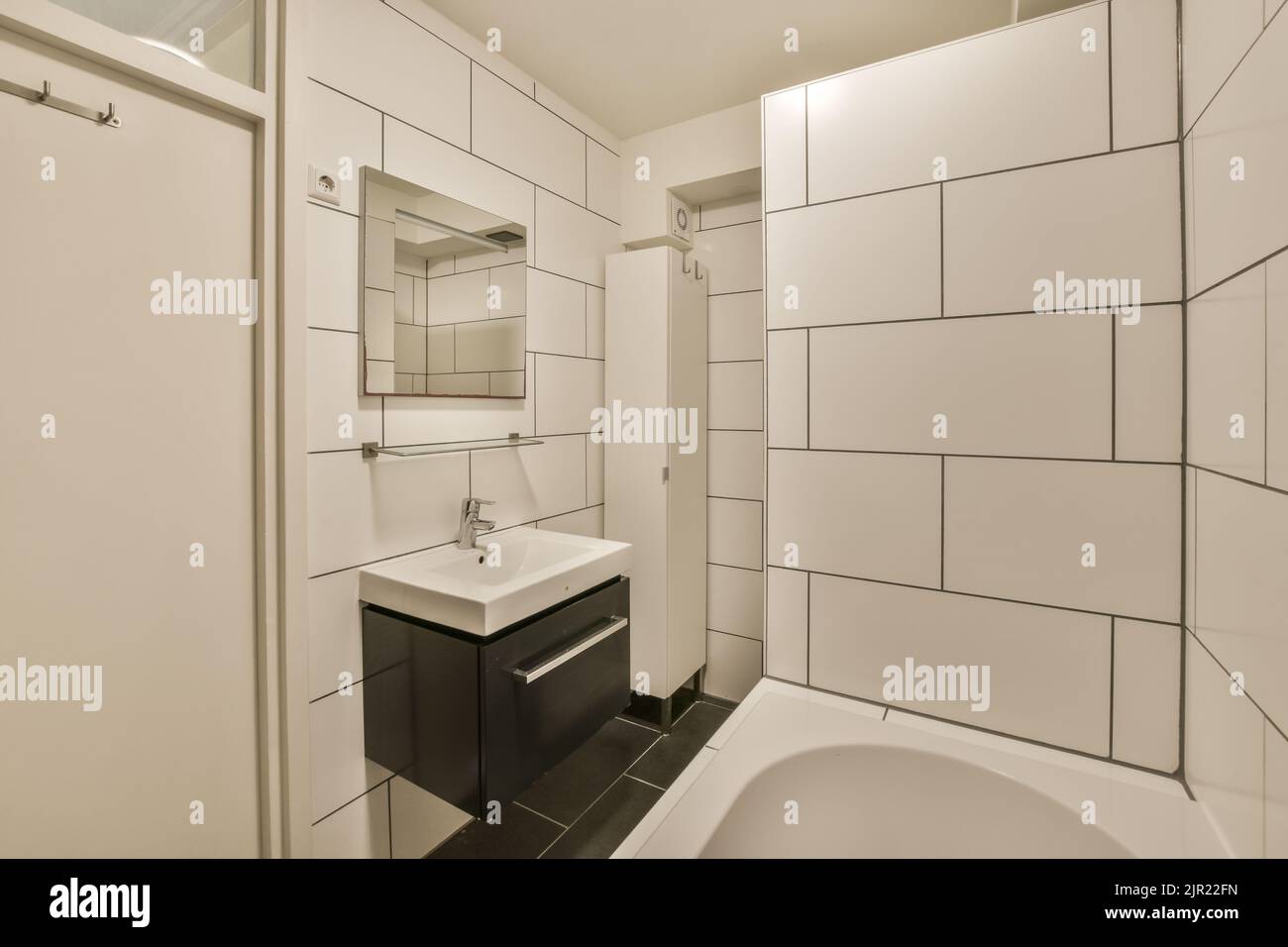 Modern home interior design of white bathroom with open bathtub and