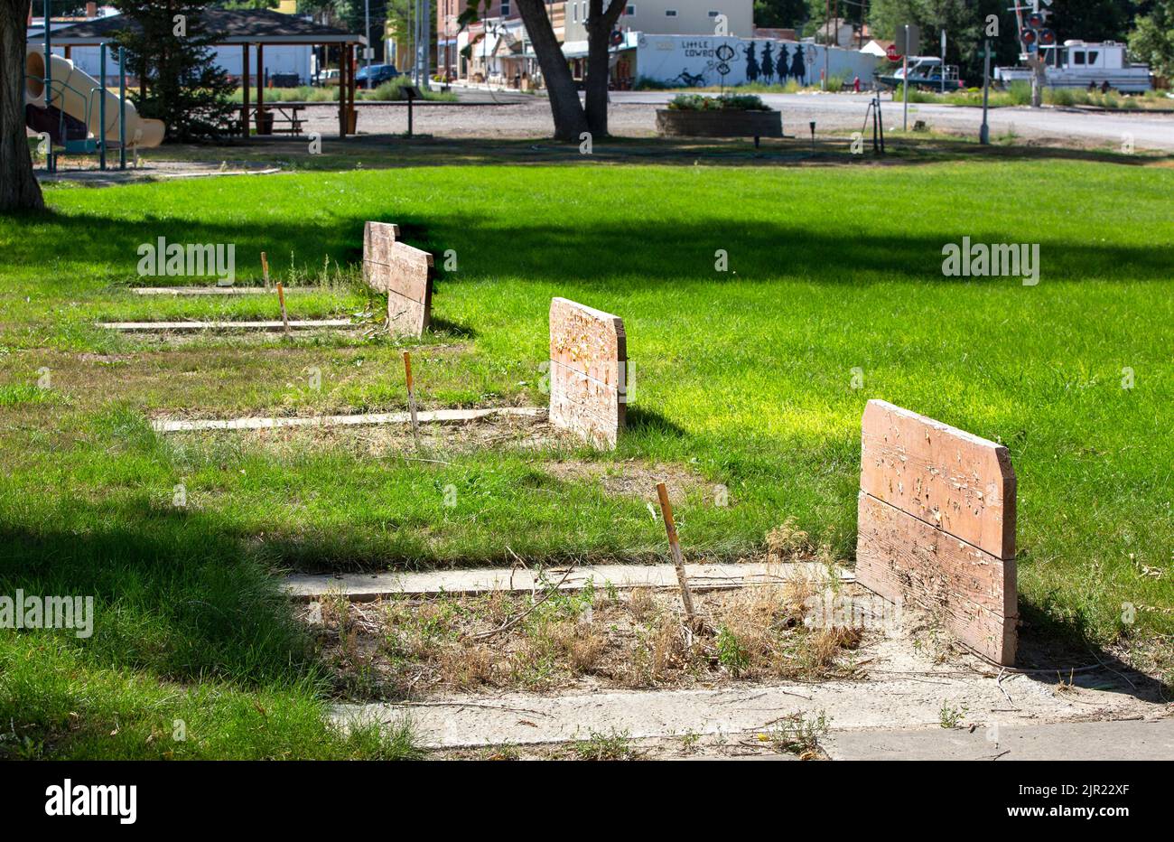 Weeds growing in unused horseshoe pits formerly used for recreation and games in a city park in Fromberg, Montana Stock Photo