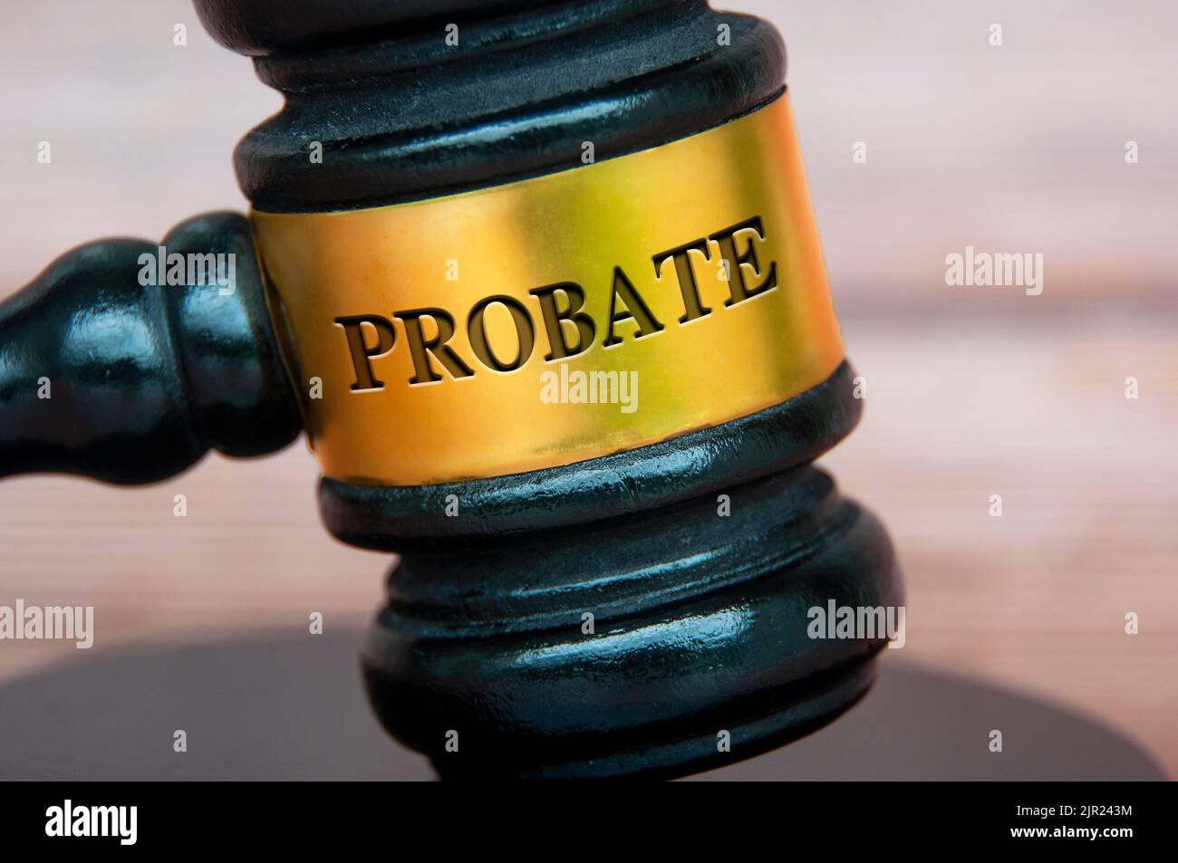 Probate text engraved on gavel with blurred wooden cover background. Legal and law concept. Stock Photo