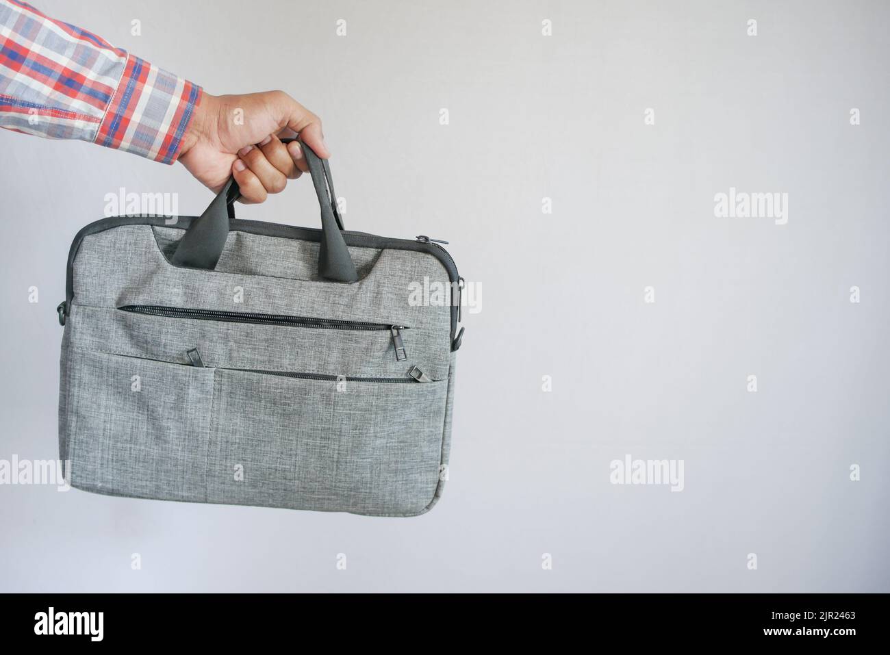 young man holding a shoulder bag Stock Photo