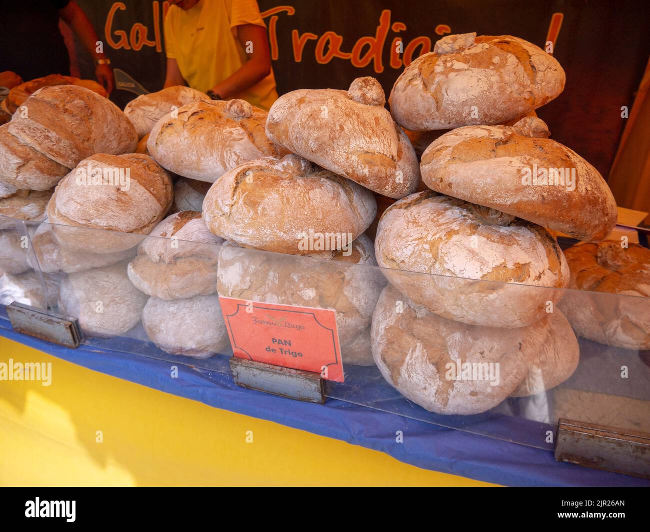 MONDONEDO, SPAIN - AUGUST 14, 2022: Traditional galician wheat bread at the medieval fair counter in the old town Mondonedo,Lugo,Galicia,Spain Stock Photo