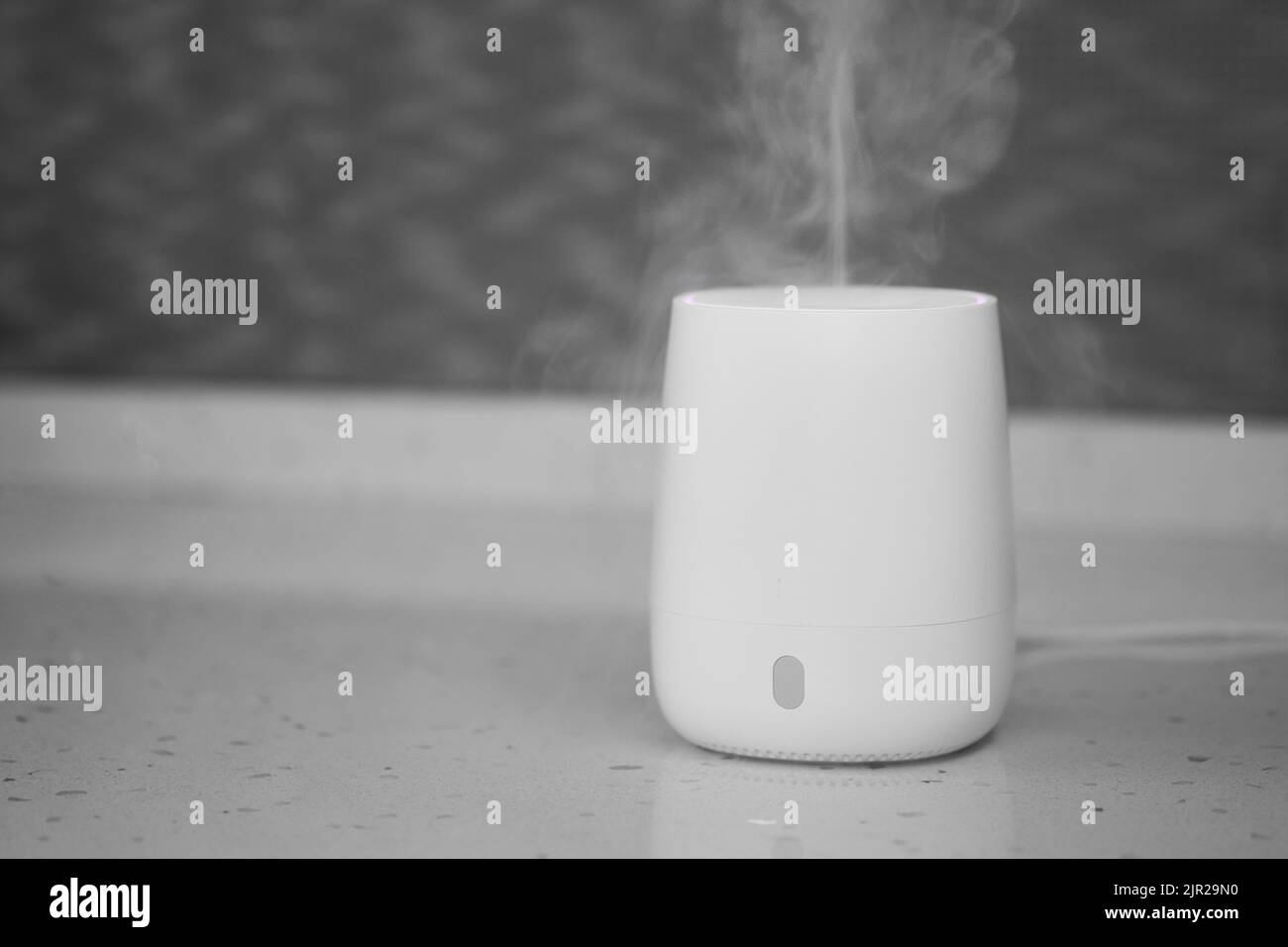 Air humidifier stands on tabletop surface Stock Photo Alamy