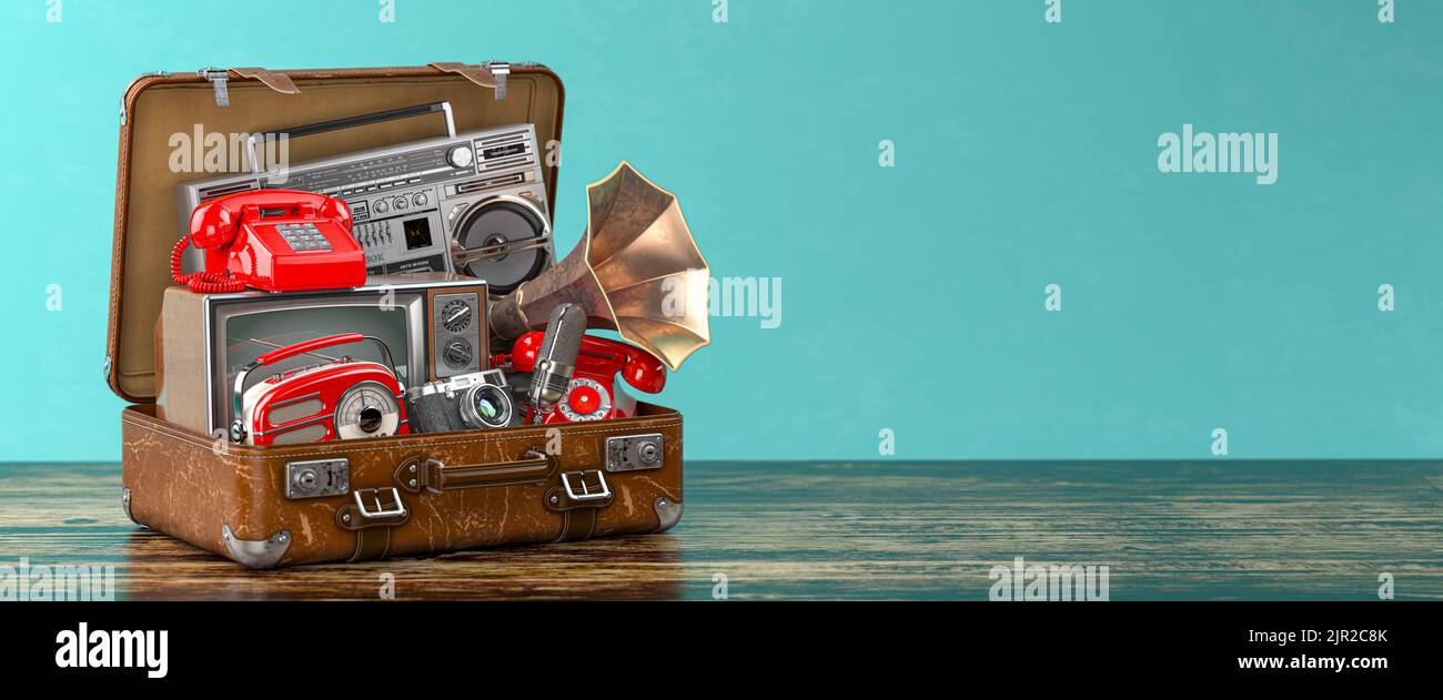 Vintage electrical and electronic appliances in an old suitcase. Nostalgic retro objects from the past 1960s - 1980s on green backgound. 3d illustrati Stock Photo