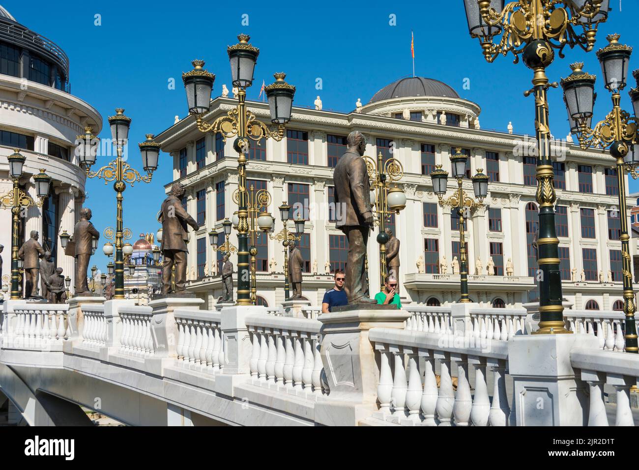The art bridge across the Vandar river with the Financial Police Office and Foreign Ministery building in the background.Skopje, North Macedonia. Stock Photo