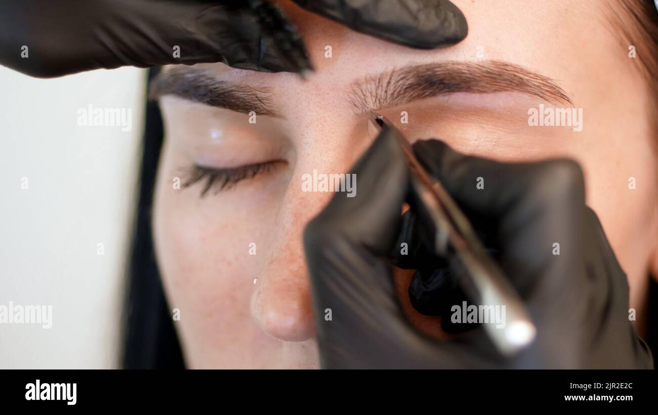 beauty saloon. closeup, hands of the cosmetician in black rubber