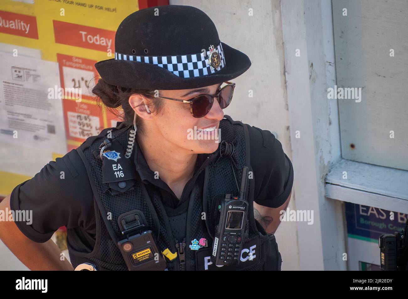 A female Sussex police officer on duty on Eastbourne seafront in East Sussex, UK. Stock Photo