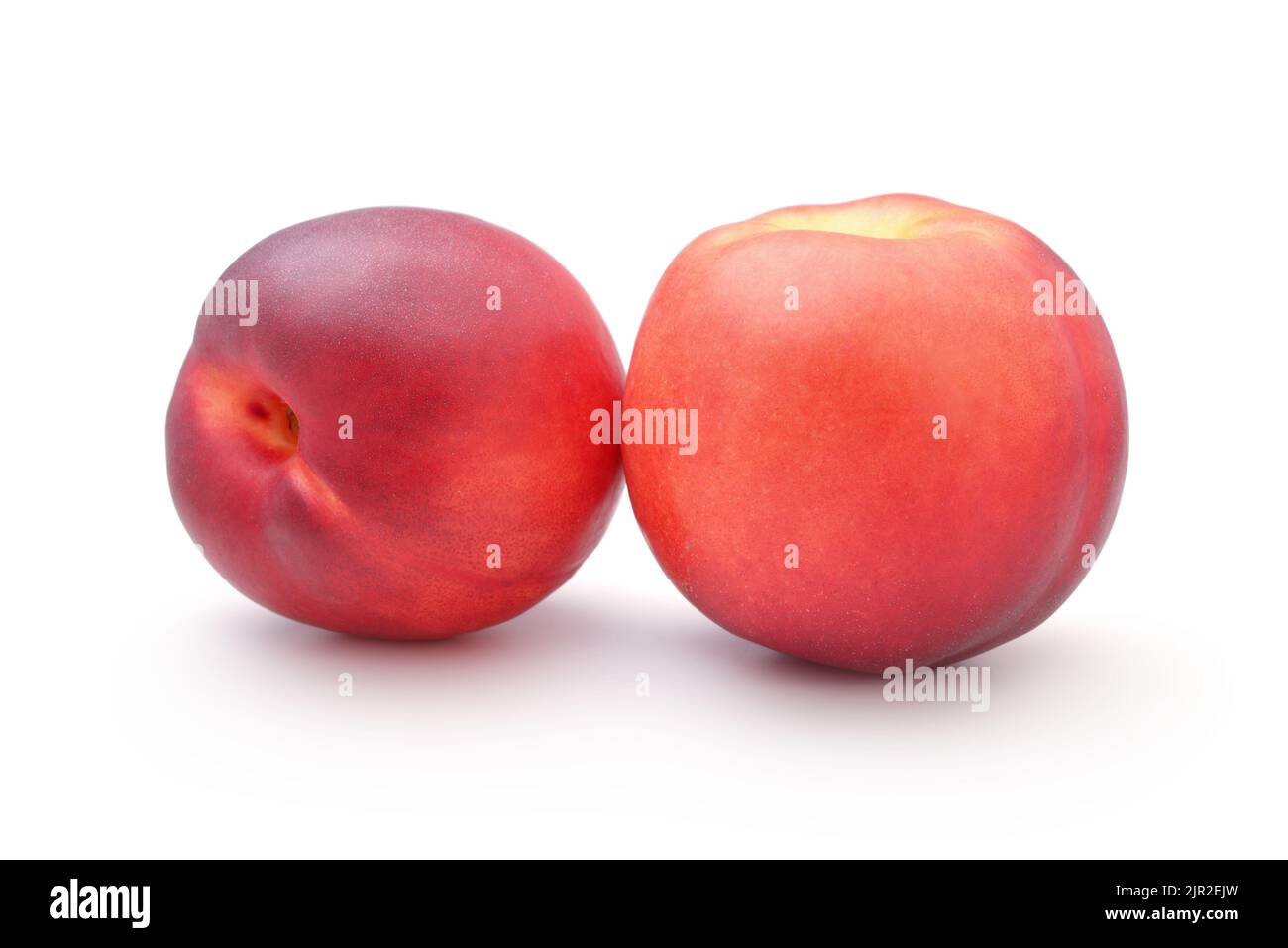 Two ripe fresh nectarines isolated on white. Stock Photo