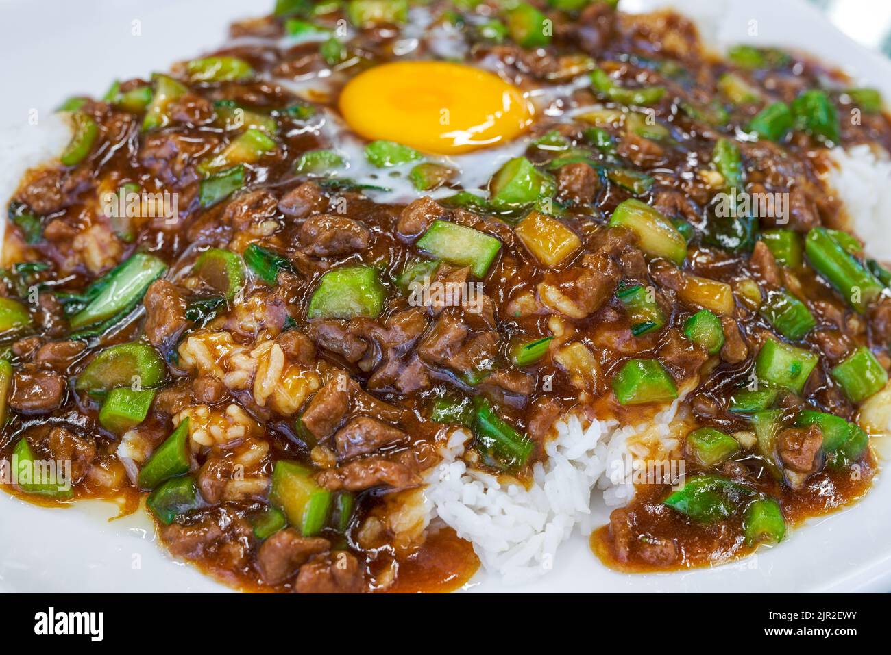 A plate of delicious and tempting nest egg minced beef rice in a Hong