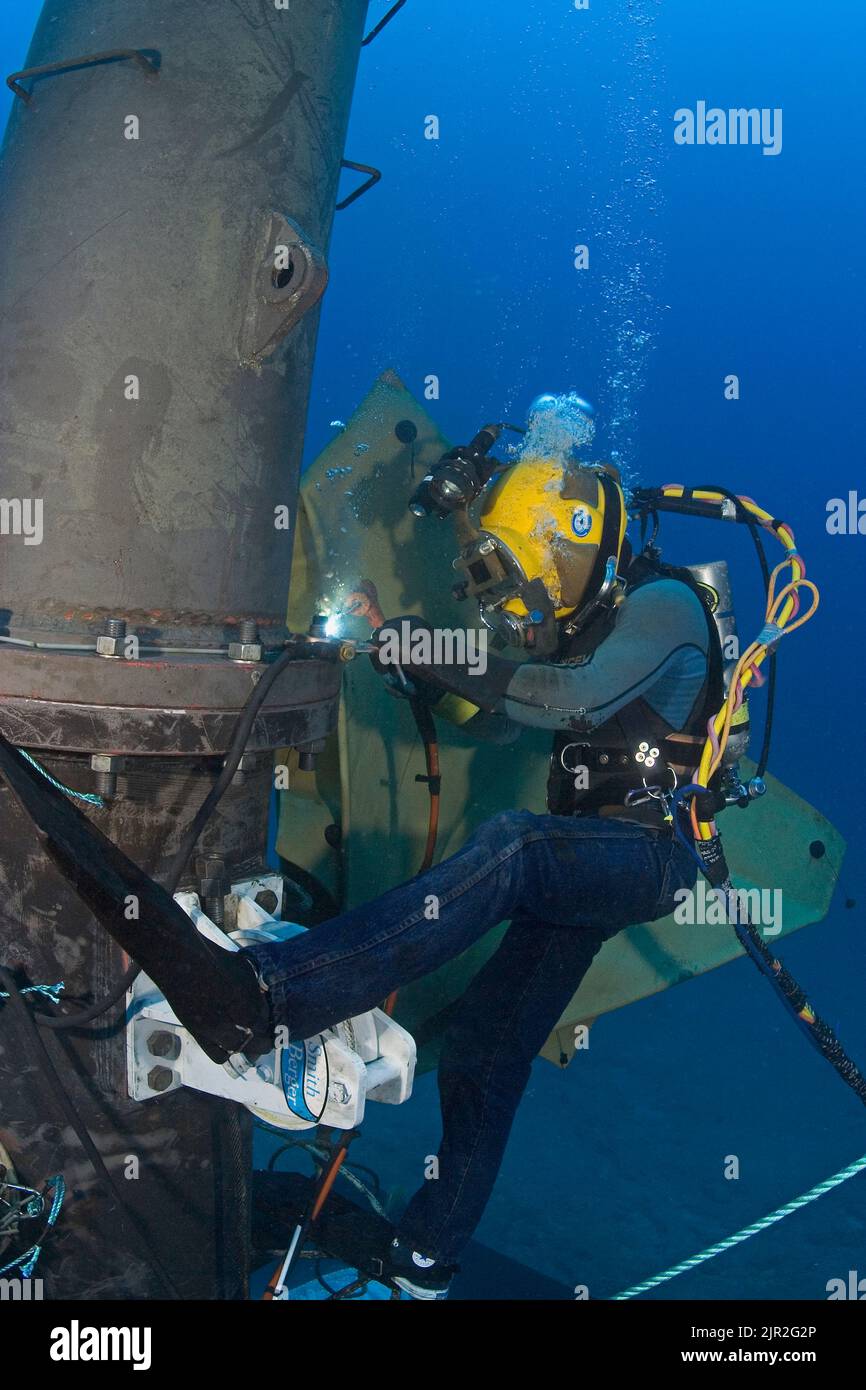 A commercial hard hat diver (MR) welding underwater off Oahu, Hawaii