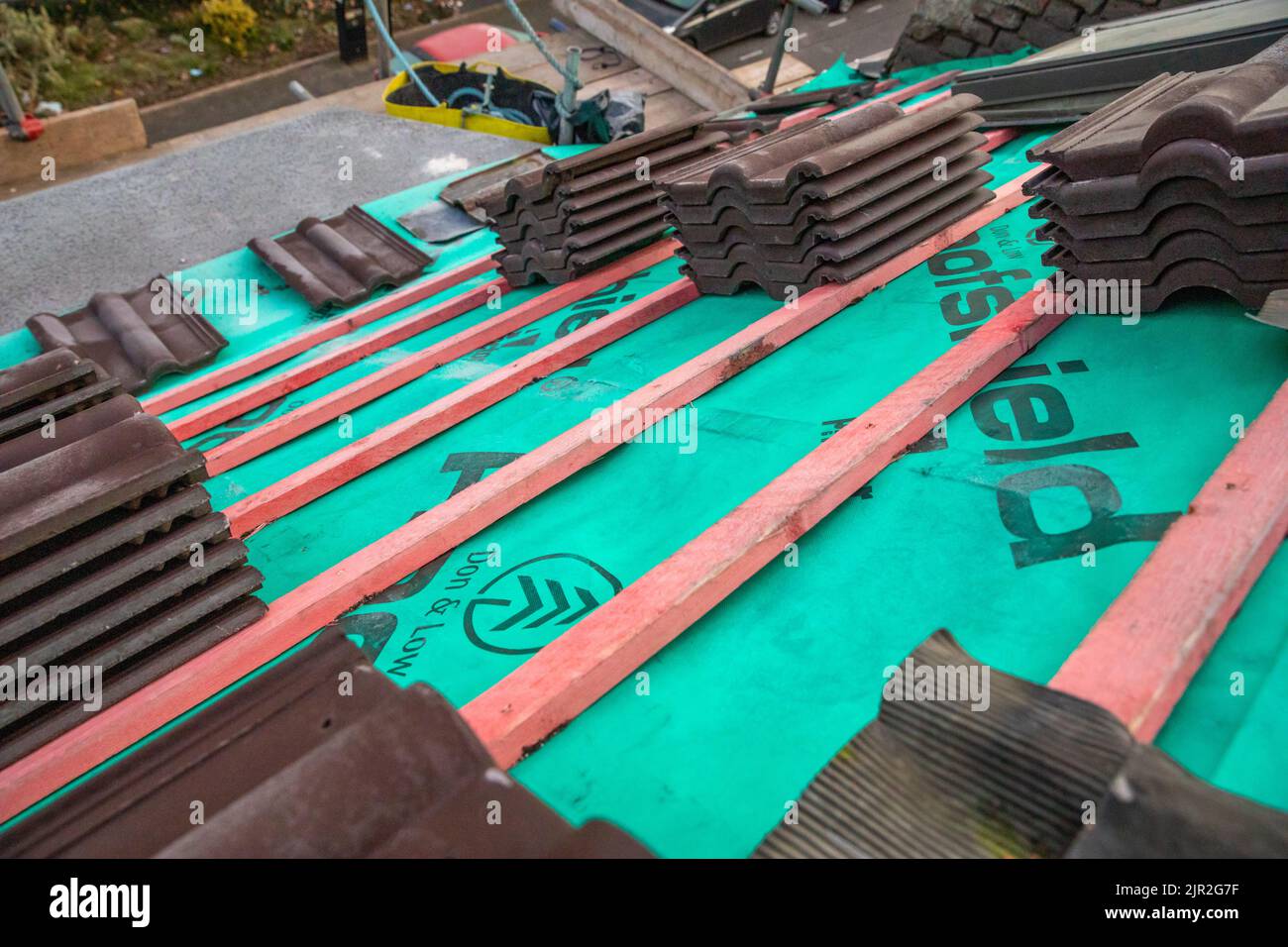 A roof being tiled Stock Photo