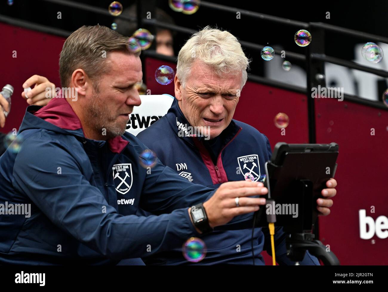 London, UK. 21st Aug, 2022. London UK 21st August 2022Kevin Nolan (West Ham first team coach, left) and David Moyes (West Ham manager) look at a screen through the bubbles during the West Ham vs Brighton Premier League match at the London Stadium Stratford. Credit: MARTIN DALTON/Alamy Live News Stock Photo