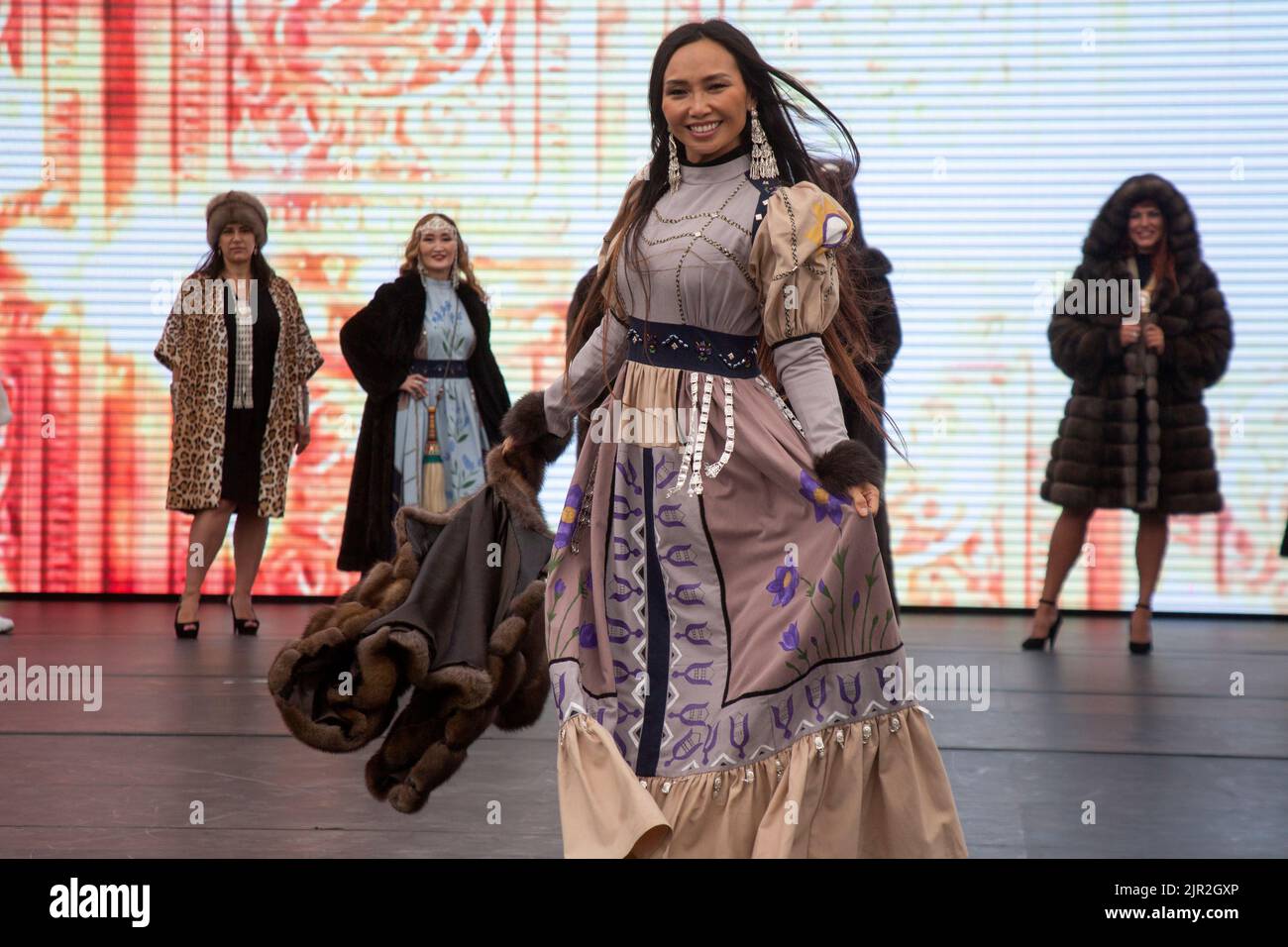 Moscow, Russia. 21th of August, 2022. Fashion show of dresses and fur coats by Yakut designers on a stage of the V Festival of the Russian Geographical Society in Zaryadye Park in the center of Moscow, Russia Stock Photo