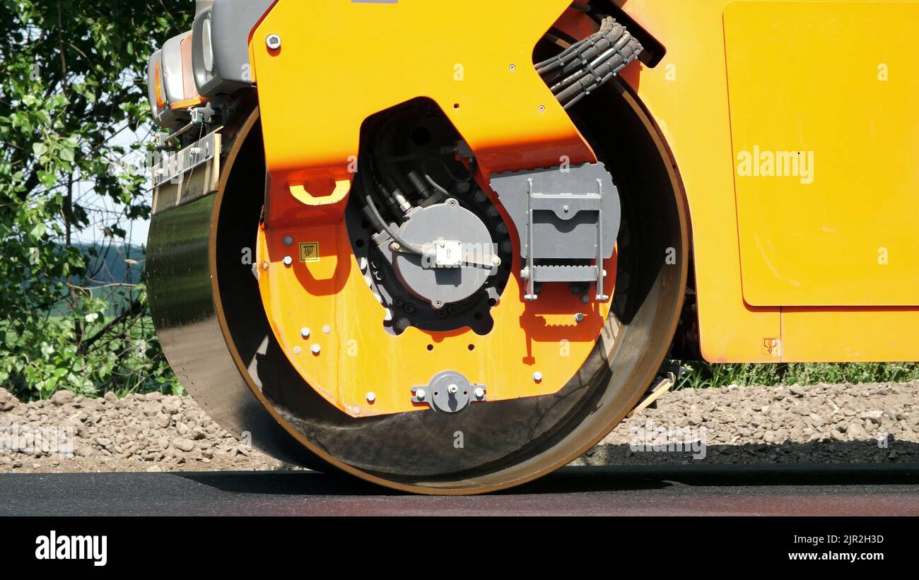 closeup, Road construction works with roller compactor machine and asphalt finisher. Road