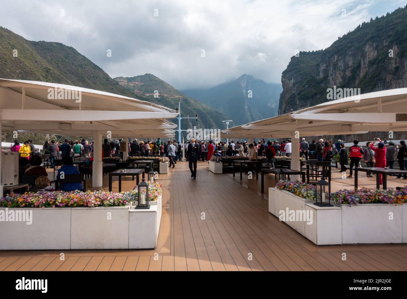 Guests on board a river cruise admire scenery of the Three Gorges on the Yangtze River in China Stock Photo