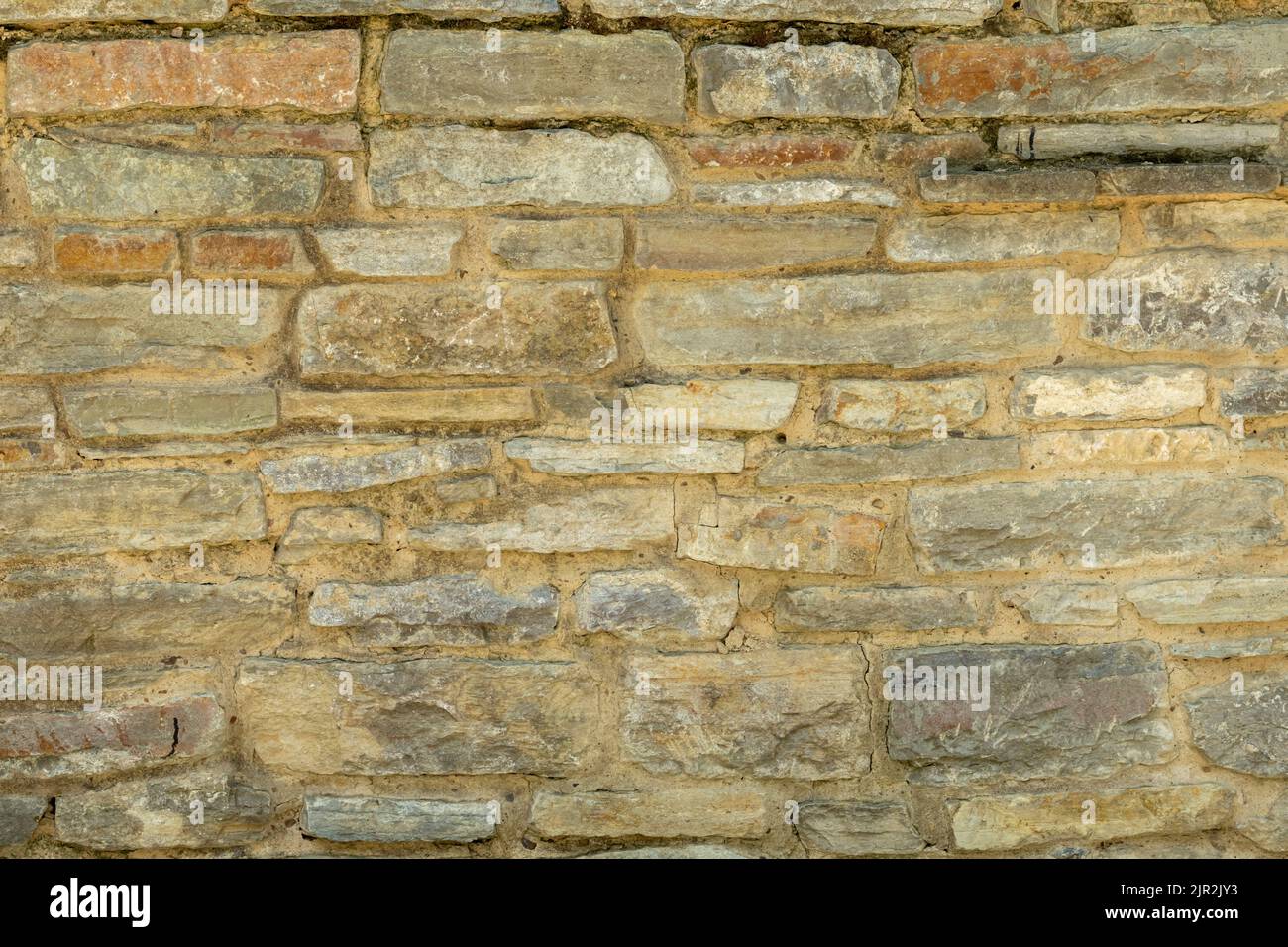 Solid yellow and beige stone wall. Stone background. Stock Photo