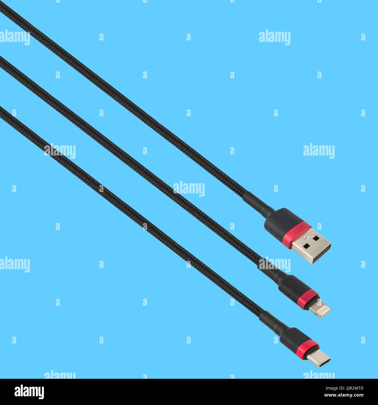 Cable with USB, Type-C and Lightning connector, isolated on a blue background Stock Photo