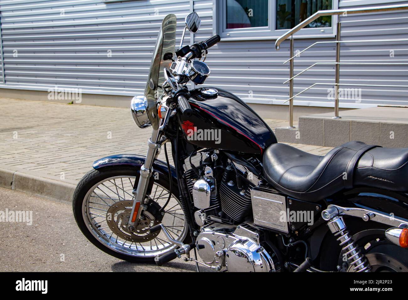 Beautiful powerful motorcycle cruiser stands on a rural road near the house. Freedom and tourism concept. Lida, Belarus - August 29, 2017. Stock Photo