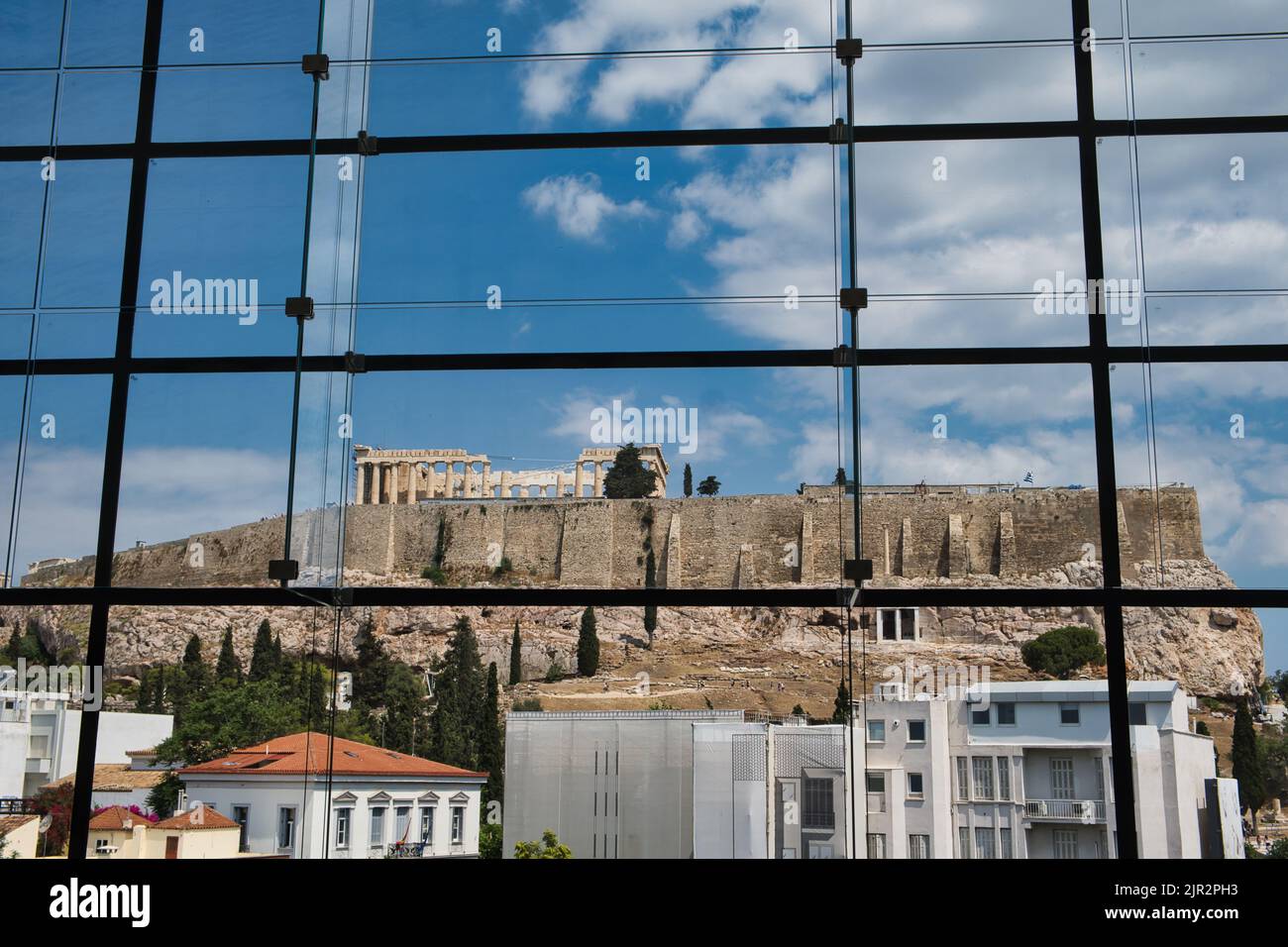 View of the Acropolis from the glass windows of the Acropolis museum in ...