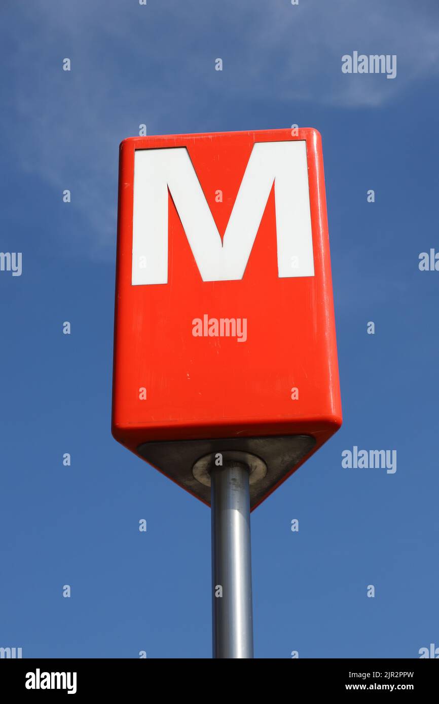 Helsinki, Finland - August 20, 2022: Close-up view of the Helsinki metro station entrance sign against a blue sky. Stock Photo